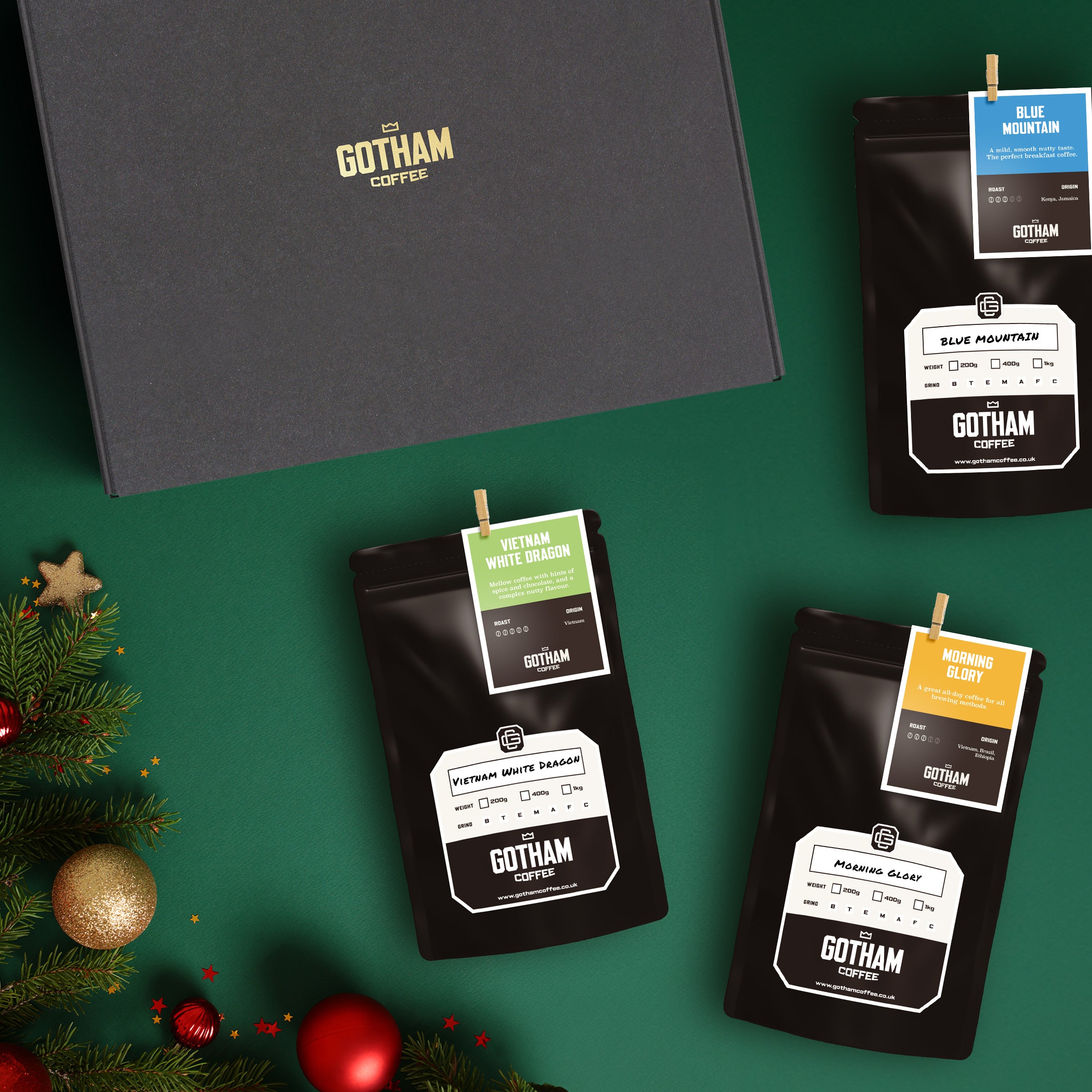 Gotham Coffee packages on a green background with Christmas decorations